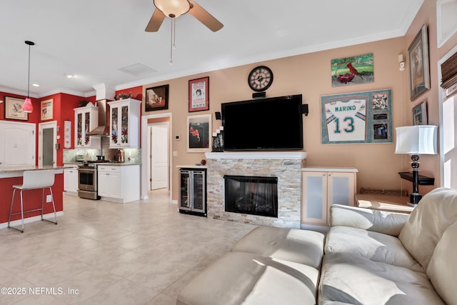 112 Long Branch Way, Saint Augustine, FL 32086 - living room with light tile patterned floors, a ceiling fan, a fireplace, crown molding, and wine cooler