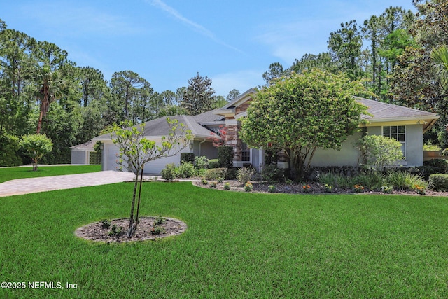112 Long Branch Way, Saint Augustine, FL 32086 - view of front of house featuring a garage, stucco siding, a front lawn, a shingled roof, and driveway