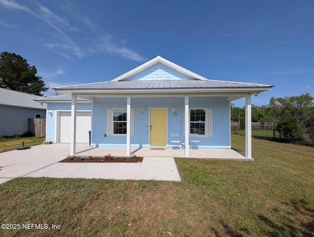 109 N Peachtree St, Hastings, FL 32145 - view of front of home featuring a porch, concrete driveway, an attached garage, and metal roof