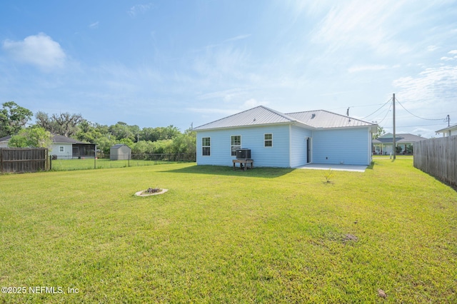 109 N Peachtree St, Hastings, FL 32145 - rear view of house with a patio area, a fire pit, and metal roof