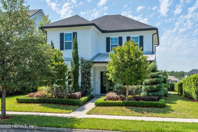 view of front of home featuring a shingled roof and metal roof