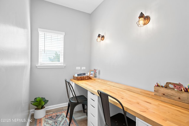 office with built in study area and baseboards