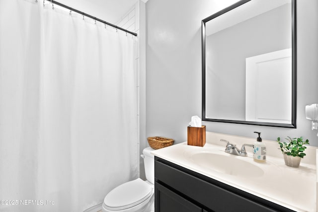 bathroom with toilet, vanity, and a shower with shower curtain