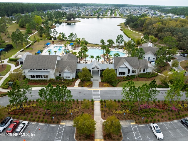 bird's eye view of a pool area and a large body of water