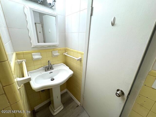 6332 Badnur Dr, Jacksonville, FL 32210 - bathroom featuring tile walls and wood finished floors