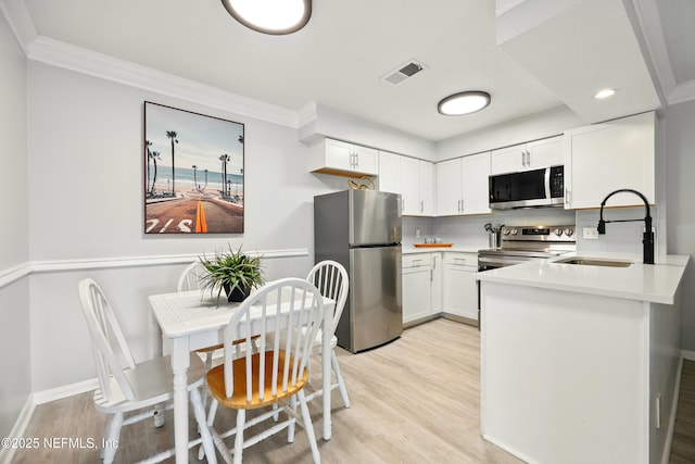100 Fairway Park Blvd Unit 1809, Ponte Vedra Beach, FL 32082 - kitchen with appliances with stainless steel finishes, a sink, light wood-type flooring, backsplash, and crown molding