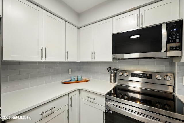 100 Fairway Park Blvd Unit 1809, Ponte Vedra Beach, FL 32082 - kitchen featuring stainless steel appliances, white cabinets, tasteful backsplash, and light countertops