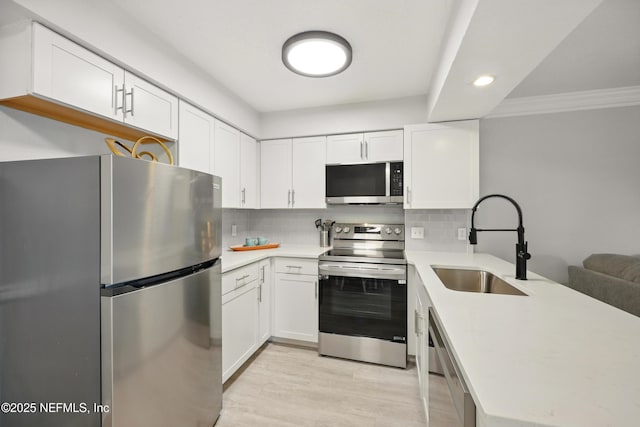 100 Fairway Park Blvd Unit 1809, Ponte Vedra Beach, FL 32082 - kitchen featuring stainless steel appliances, a sink, a peninsula, light countertops, and white cabinets