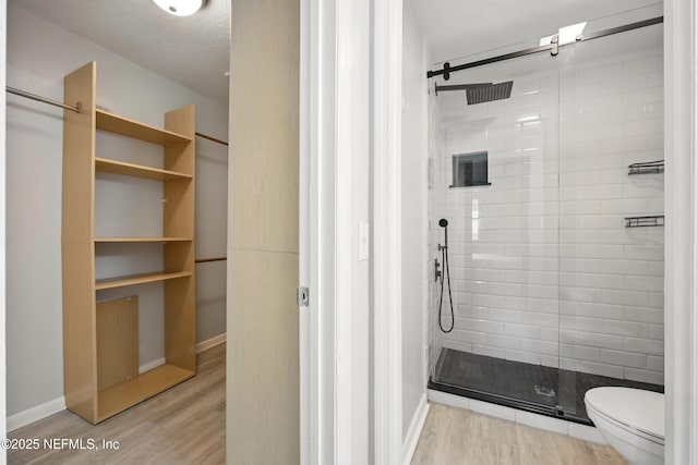 100 Fairway Park Blvd Unit 1809, Ponte Vedra Beach, FL 32082 - full bathroom featuring a stall shower, wood finished floors, toilet, and baseboards