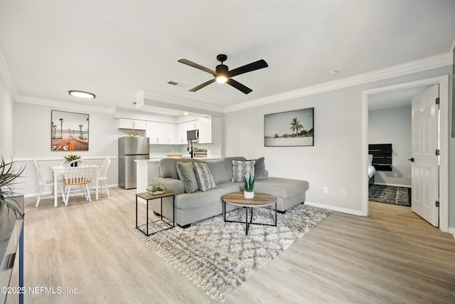 100 Fairway Park Blvd Unit 1809, Ponte Vedra Beach, FL 32082 - living room with light wood-style flooring, ceiling fan, baseboards, and crown molding