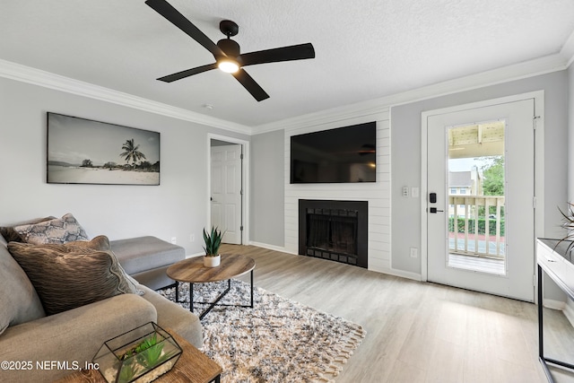 100 Fairway Park Blvd Unit 1809, Ponte Vedra Beach, FL 32082 - living area with crown molding, wood finished floors, ceiling fan, a large fireplace, and baseboards