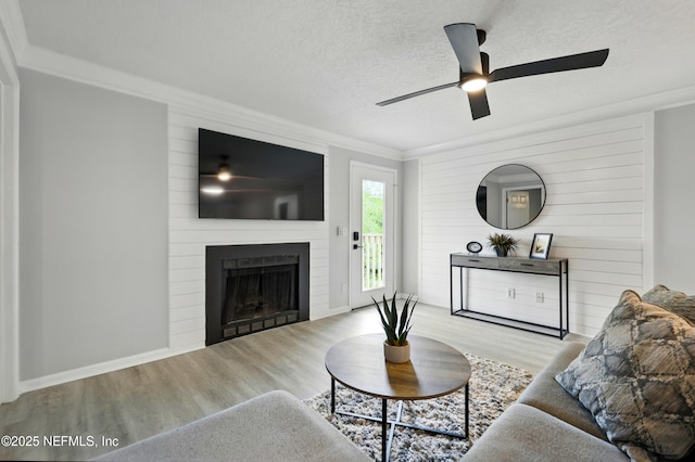 100 Fairway Park Blvd Unit 1809, Ponte Vedra Beach, FL 32082 - living area featuring wood finished floors, a ceiling fan, a large fireplace, ornamental molding, and a textured ceiling