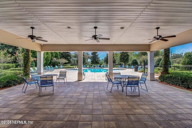6750 White Blossom Cir Unit 36A, Jacksonville, FL 32258 - view of patio / terrace with fence, a ceiling fan, and a community pool