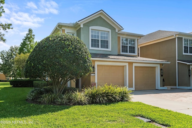 6750 White Blossom Cir Unit 36A, Jacksonville, FL 32258 - view of front of house featuring an attached garage, a front yard, stucco siding, and driveway
