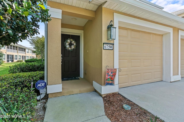 6750 White Blossom Cir Unit 36A, Jacksonville, FL 32258 - doorway to property featuring stucco siding and a garage