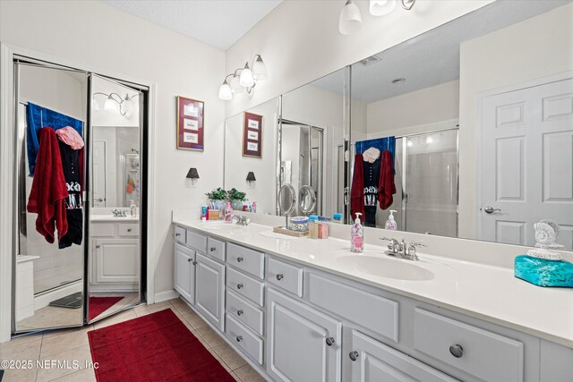 6750 White Blossom Cir Unit 36A, Jacksonville, FL 32258 - bathroom featuring a stall shower, tile patterned flooring, double vanity, and a sink