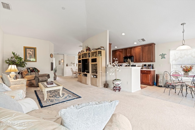 6750 White Blossom Cir Unit 36A, Jacksonville, FL 32258 - living room with vaulted ceiling, light carpet, light tile patterned floors, and visible vents