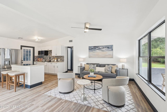 5444 Keystone Dr S, Jacksonville, FL 32207 - living area with light wood-style floors, a ceiling fan, and baseboards