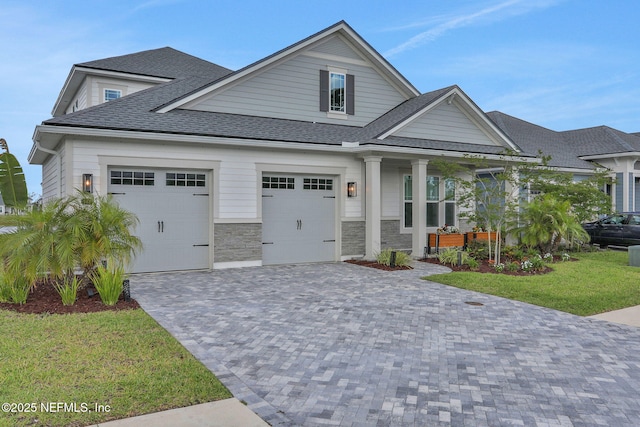 181 Lamego Ln, Saint Augustine, FL 32095 - craftsman-style home with roof with shingles, decorative driveway, an attached garage, and a front yard