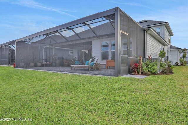 181 Lamego Ln, Saint Augustine, FL 32095 - back of house featuring a patio area, a lawn, and glass enclosure