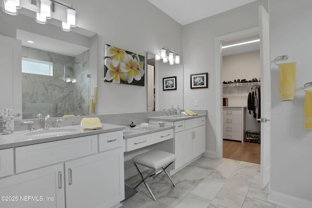 181 Lamego Ln, Saint Augustine, FL 32095 - bathroom featuring a marble finish shower, marble look tiles, a spacious closet, vanity, and baseboards
