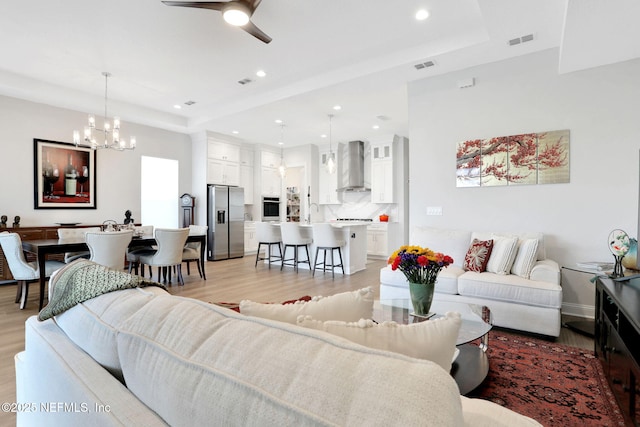 181 Lamego Ln, Saint Augustine, FL 32095 - living room featuring a chandelier, light wood-type flooring, ceiling fan, recessed lighting, and a tray ceiling