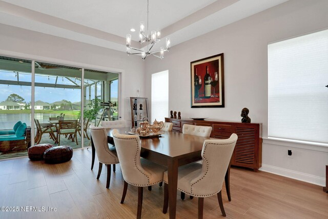 181 Lamego Ln, Saint Augustine, FL 32095 - dining space featuring a chandelier, light wood finished floors, and baseboards