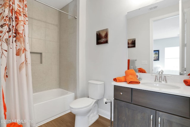 181 Lamego Ln, Saint Augustine, FL 32095 - full bath with toilet, wood finished floors, vanity, baseboards, and shower / bath combo with shower curtain