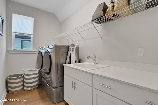 181 Lamego Ln, Saint Augustine, FL 32095 - laundry area featuring washer and clothes dryer, light wood-style floors, cabinet space, and baseboards