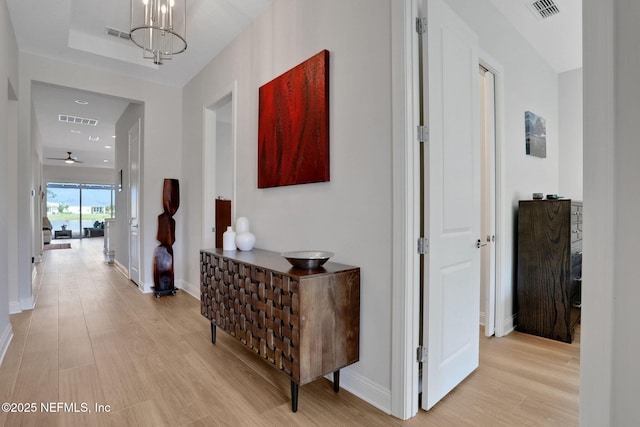 181 Lamego Ln, Saint Augustine, FL 32095 - hallway with light wood-style flooring, baseboards, and a chandelier