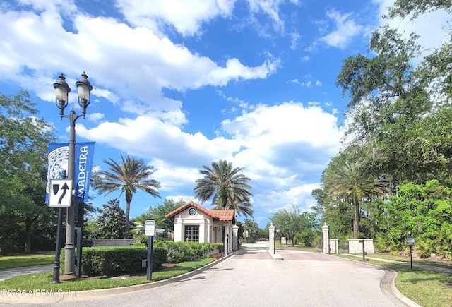 181 Lamego Ln, Saint Augustine, FL 32095 - view of asphalt road featuring curbs, a gated entry, and street lights