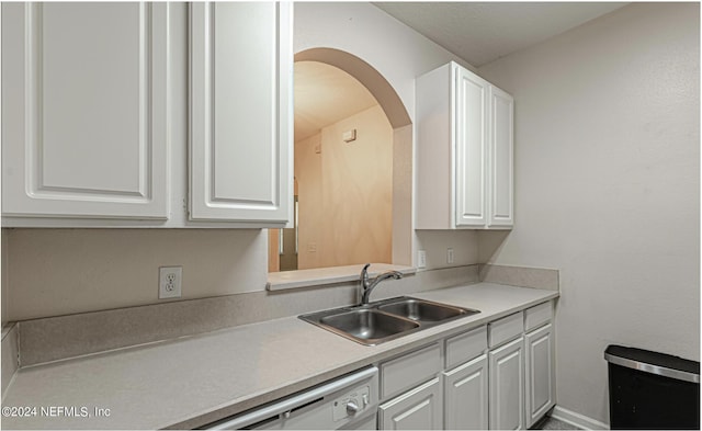 7801 Point Meadows Dr Unit 1108, Jacksonville, FL 32256 - kitchen featuring a sink, white cabinets, arched walkways, light countertops, and dishwasher