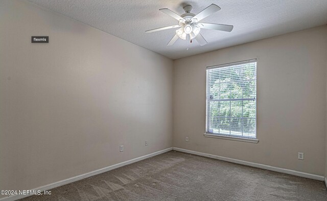 7801 Point Meadows Dr Unit 1108, Jacksonville, FL 32256 - spare room featuring a textured ceiling, carpet floors, and baseboards