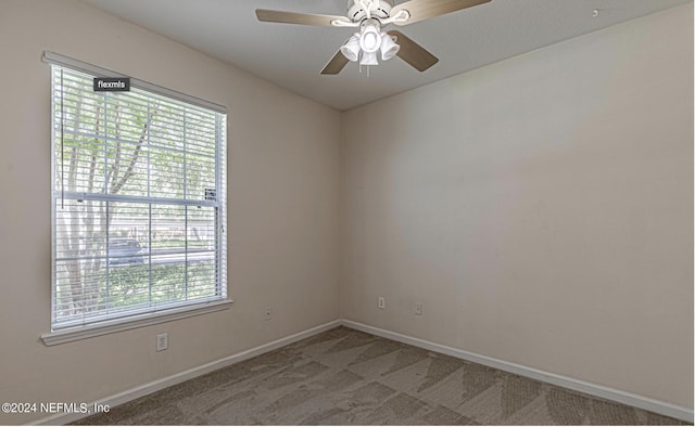 7801 Point Meadows Dr Unit 1108, Jacksonville, FL 32256 - spare room featuring light carpet, baseboards, and ceiling fan