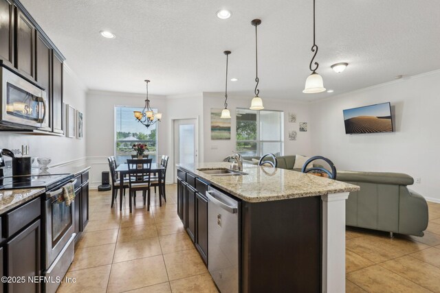 1500 Calming Water Dr Unit 3504, Fleming Island, FL 32003 - kitchen with stainless steel appliances, a sink, ornamental molding, dark brown cabinets, and decorative light fixtures