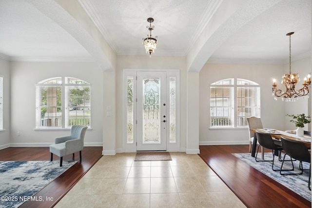 5279 Cattle Crossing Way, Jacksonville, FL 32226 - foyer entrance featuring baseboards, ornamental molding, a chandelier, and wood finished floors