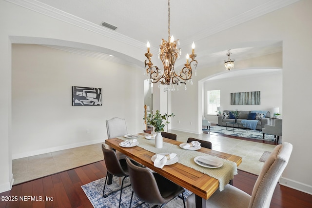 5279 Cattle Crossing Way, Jacksonville, FL 32226 - dining space with an inviting chandelier, visible vents, arched walkways, and hardwood / wood-style flooring