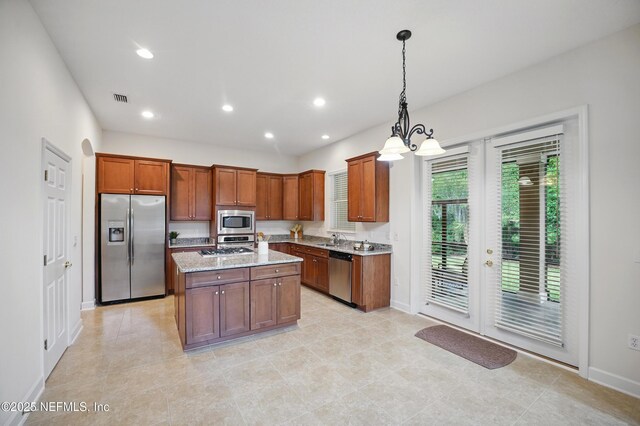 5279 Cattle Crossing Way, Jacksonville, FL 32226 - kitchen featuring a sink, stainless steel appliances, visible vents, hanging light fixtures, and baseboards