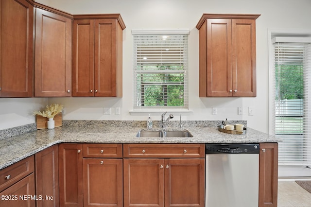 5279 Cattle Crossing Way, Jacksonville, FL 32226 - kitchen featuring brown cabinetry, light stone countertops, a sink, and stainless steel dishwasher