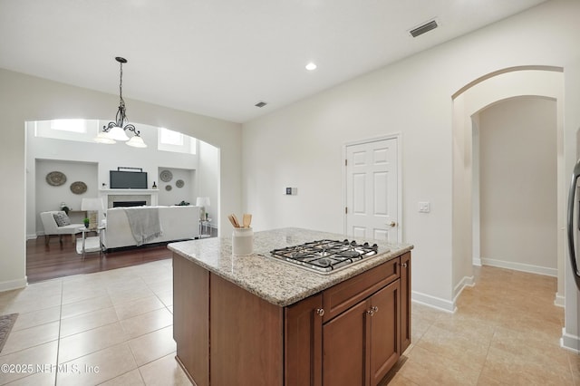 5279 Cattle Crossing Way, Jacksonville, FL 32226 - kitchen with arched walkways, light tile patterned floors, visible vents, and stainless steel gas stovetop