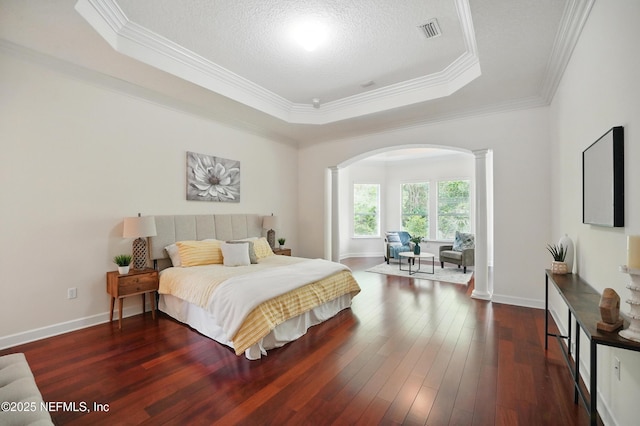 5279 Cattle Crossing Way, Jacksonville, FL 32226 - bedroom featuring arched walkways, a tray ceiling, visible vents, and decorative columns