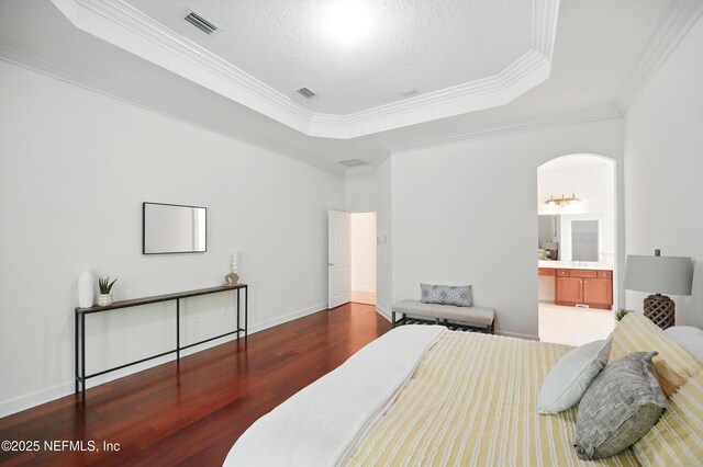 5279 Cattle Crossing Way, Jacksonville, FL 32226 - bedroom featuring a tray ceiling, crown molding, wood finished floors, and arched walkways