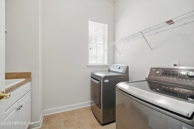 5279 Cattle Crossing Way, Jacksonville, FL 32226 - clothes washing area with washer and dryer, cabinet space, baseboards, and a sink