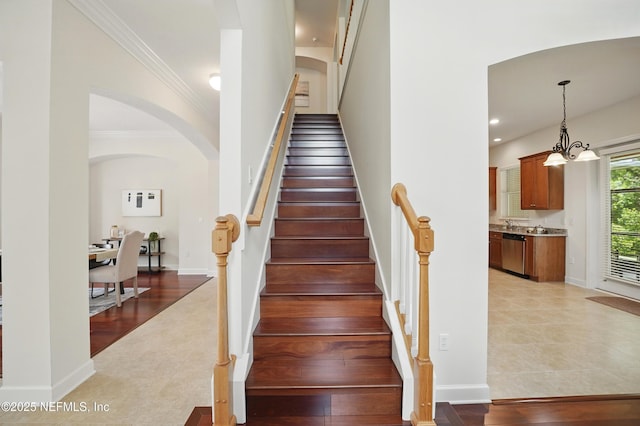 5279 Cattle Crossing Way, Jacksonville, FL 32226 - stairs featuring ornamental molding, recessed lighting, a chandelier, arched walkways, and baseboards