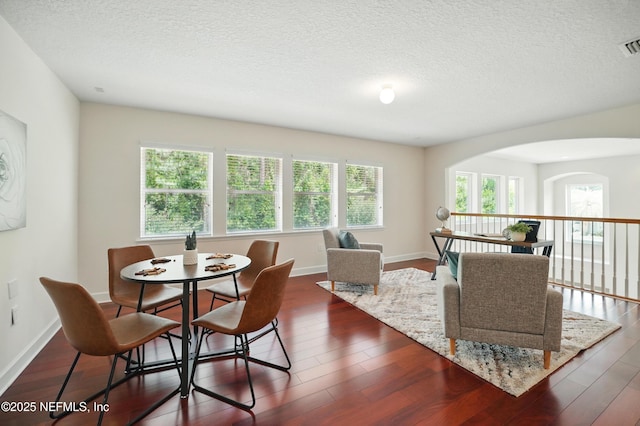 5279 Cattle Crossing Way, Jacksonville, FL 32226 - dining space with a textured ceiling, baseboards, dark wood-type flooring, and visible vents