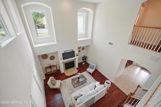 5279 Cattle Crossing Way, Jacksonville, FL 32226 - living room featuring a towering ceiling, arched walkways, a healthy amount of sunlight, and visible vents