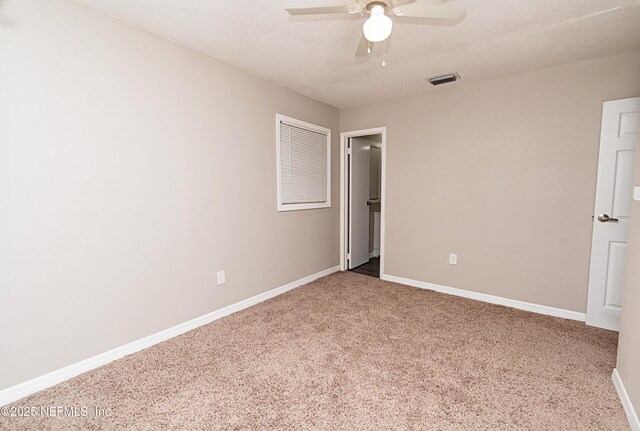 610 S 9th St, Macclenny, FL 32063 - unfurnished bedroom featuring a textured ceiling, baseboards, carpet flooring, ceiling fan, and visible vents