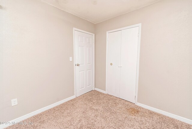610 S 9th St, Macclenny, FL 32063 - unfurnished bedroom featuring carpet, a closet, and baseboards