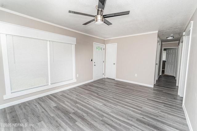 unfurnished living room with ceiling fan, baseboards, and wood finished floors