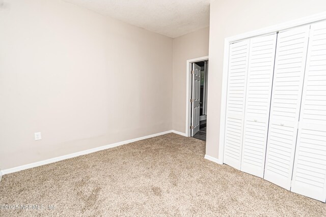 610 S 9th St, Macclenny, FL 32063 - unfurnished bedroom featuring baseboards, a textured ceiling, a closet, and carpet floors